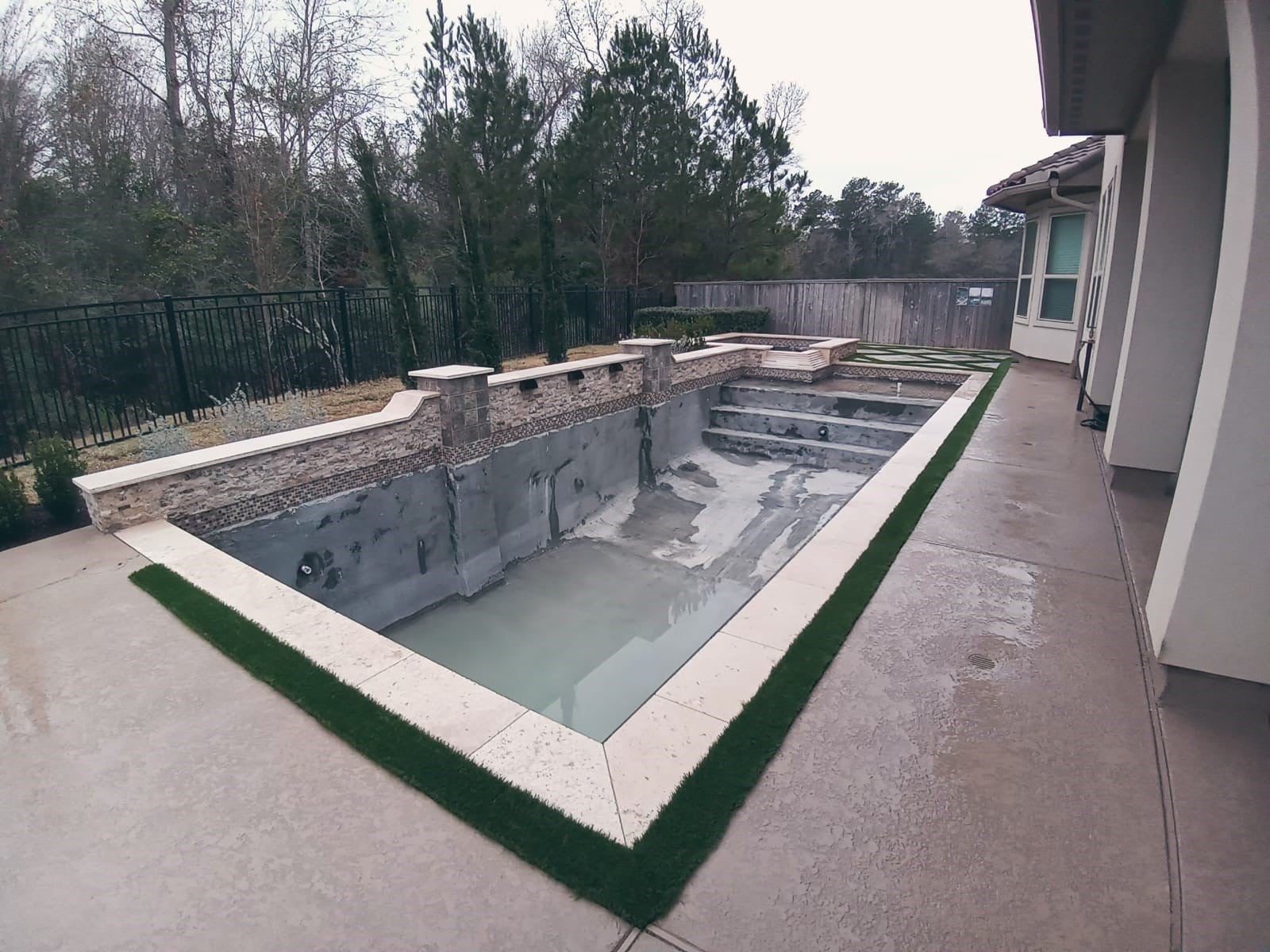 A Pool Featuring Sturdy Concrete Walls And A Sleek Concrete Deck